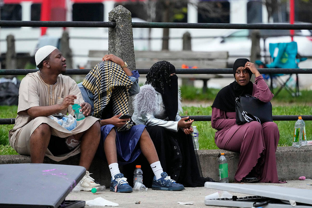 People gather in the aftermath of a shooting at an Eid al-Fitr event in Philadelphia, Wednesday ...