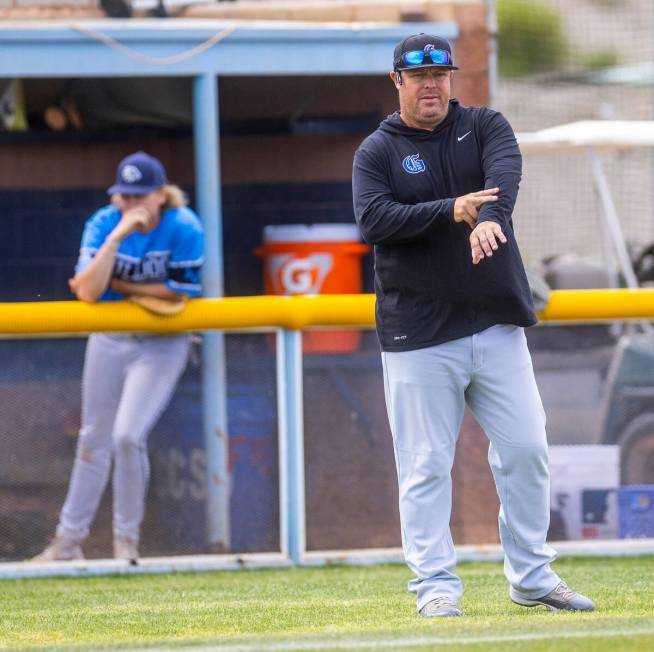 Bishop Gorman coach Chris Sheff signals to his runner against Centennial during the first innin ...