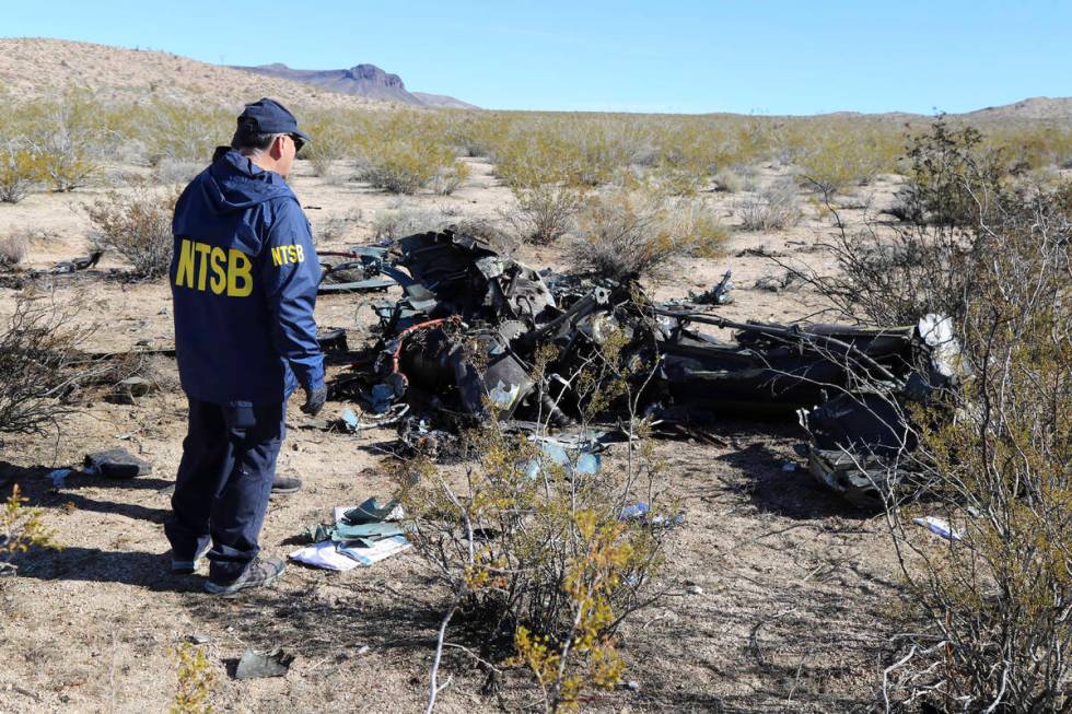 An NTSB investigator surveys the site of an Airbus Helicopters EC-130 on Sunday, Feb. 11, 2024, ...