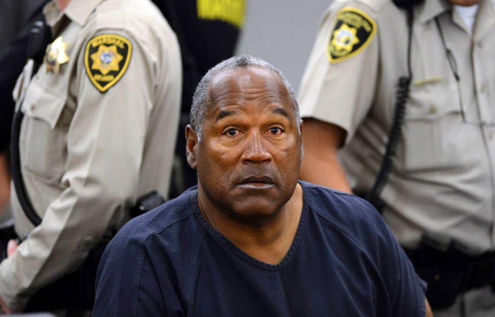 FILE - In this May 14, 2013, file photo, O.J. Simpson sits during a break on the second day of ...
