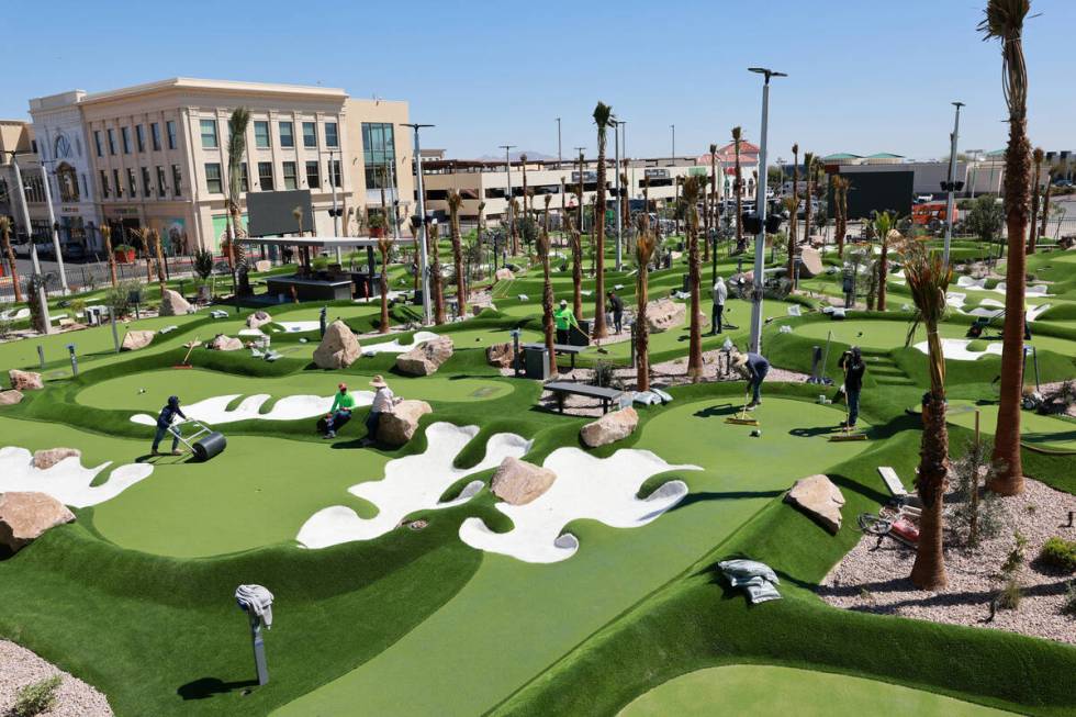 Workers put the finishing touches PopStroke mini-golf and entertainment facility at Town Square ...