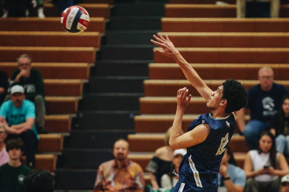 Shadow Ridge setter Kingston Jerome (12) hits the ball back over the net during a volleyball ma ...