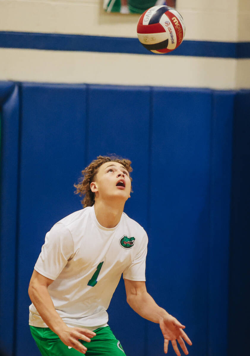 Green Valley outside hitter Taylor Beck watches the ball go into the air as he serves it during ...