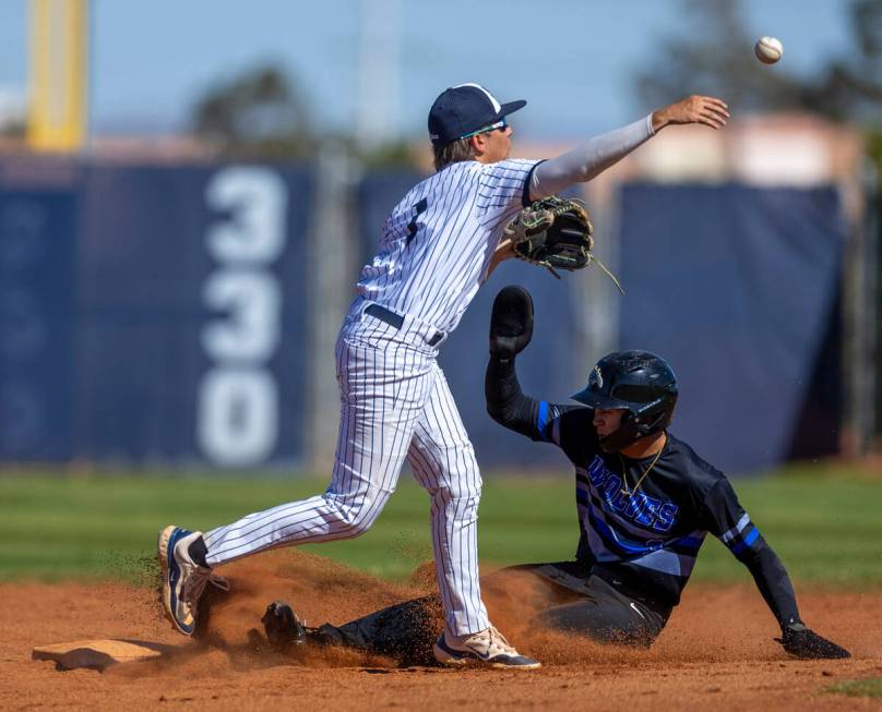 Basic runner Ty Southisene slides below Spring Valley second baseman Logan Rose after the tag d ...