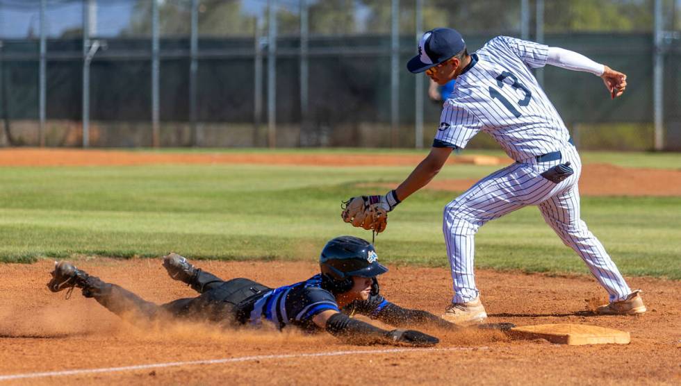 Basic runner Ty Southisene beats a tag by Spring Valley infielder Eddie Zurita at third base du ...