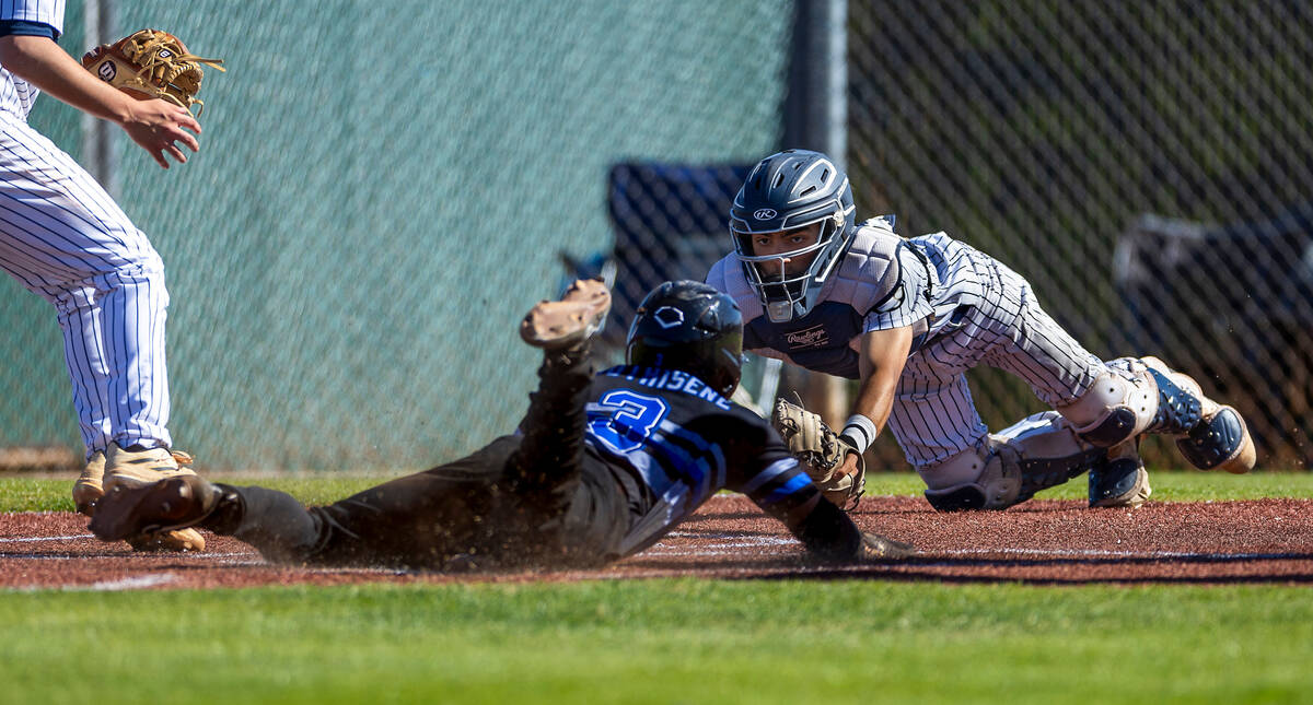 Spring Valley catcher Cameron Pienta stretches toward Basic runner Ty Southisene who safely div ...