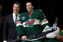 Minnesota Wild general manager Bill Guerin and goaltender Marc-Andre Fleury (29) pose with a si ...