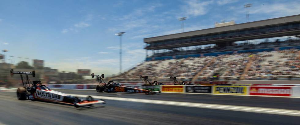 Top Fuel cars move down the track during Day 1 of NHRA 4-Wide Nationals on "The Strip&quot ...