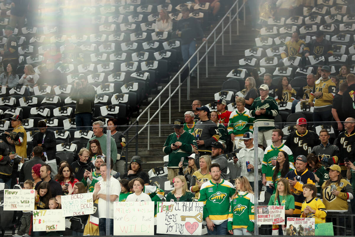 Golden Knights and Wild fans hold signs for former Golden Knight and Wild goaltender Marc-Andre ...