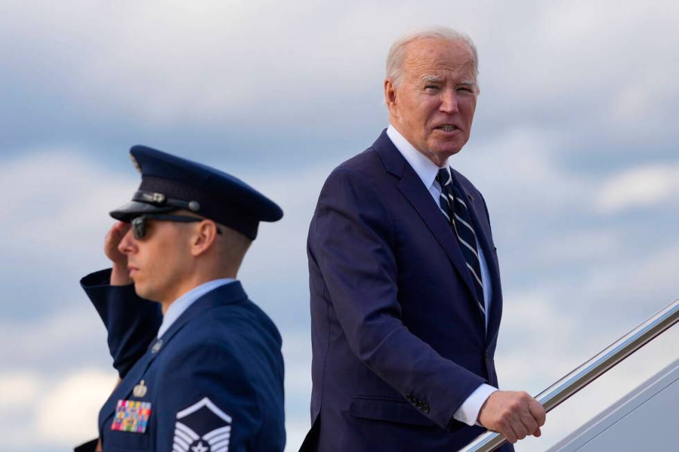 President Joe Biden pauses to respond to a question from a member of the traveling press as he ...