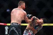 Max Holloway punches Justin Gaethje for a knockout during a UFC 300 mixed martial arts lightwei ...