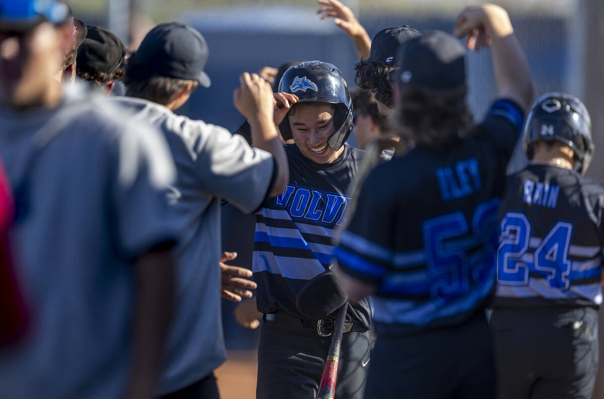 Basic players celebrate more runs against Spring Valley during the sixth inning of their NIAA b ...