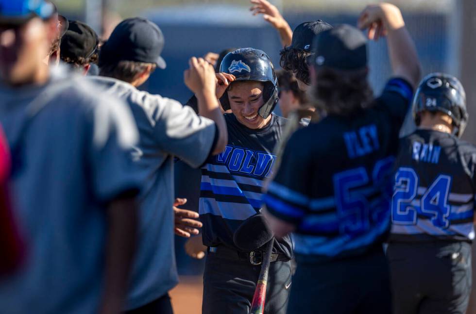 Basic players celebrate more runs against Spring Valley during the sixth inning of their NIAA b ...