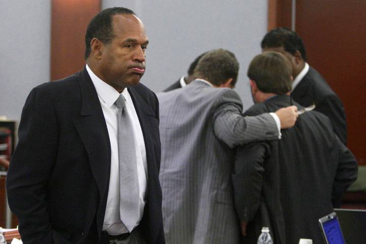 O.J. Simpson appears during his trial as co-defendant Clarence "C.J." Stewart confers with his ...