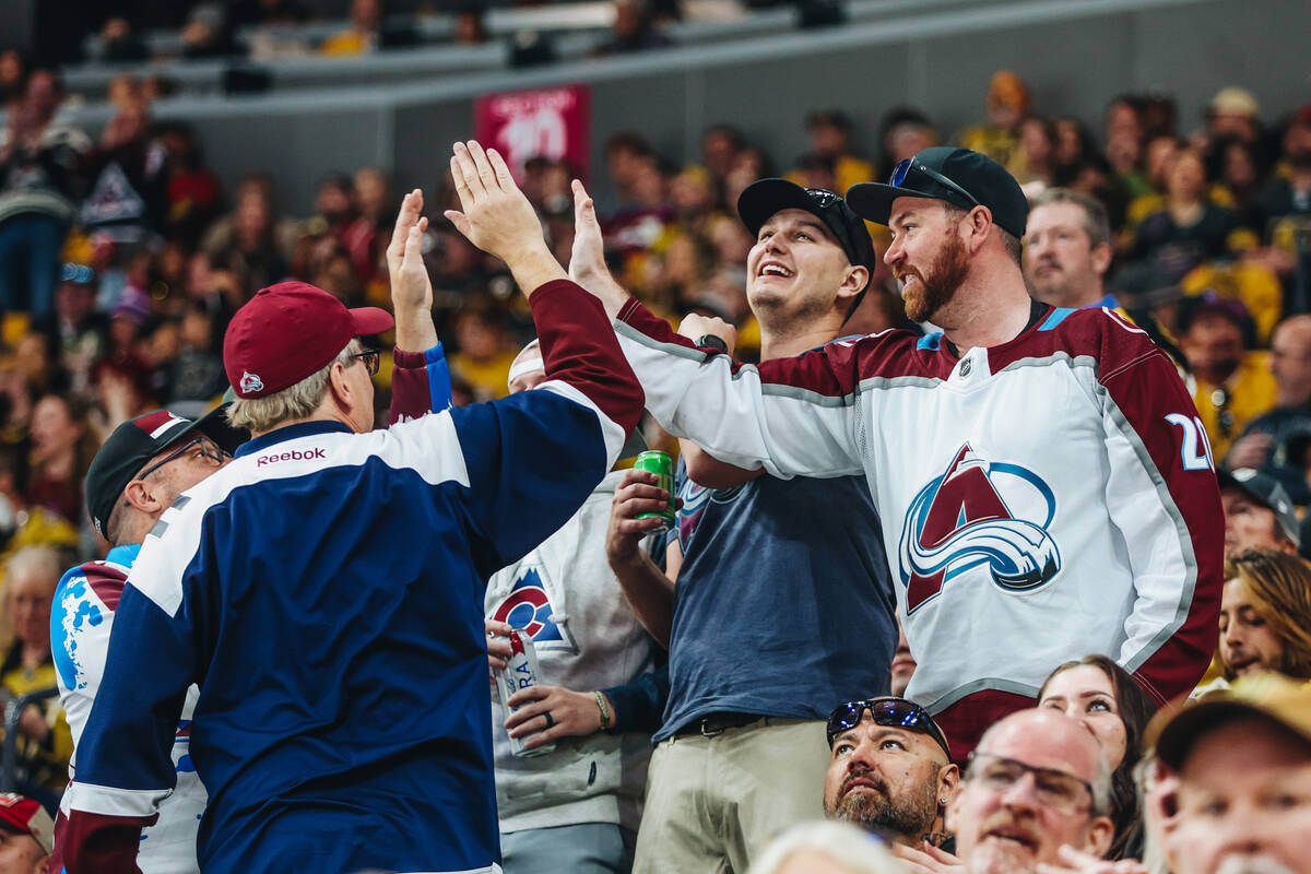 Colorado Avalanche fans celebrate a goal during an NHL hockey game between the Golden Knights a ...