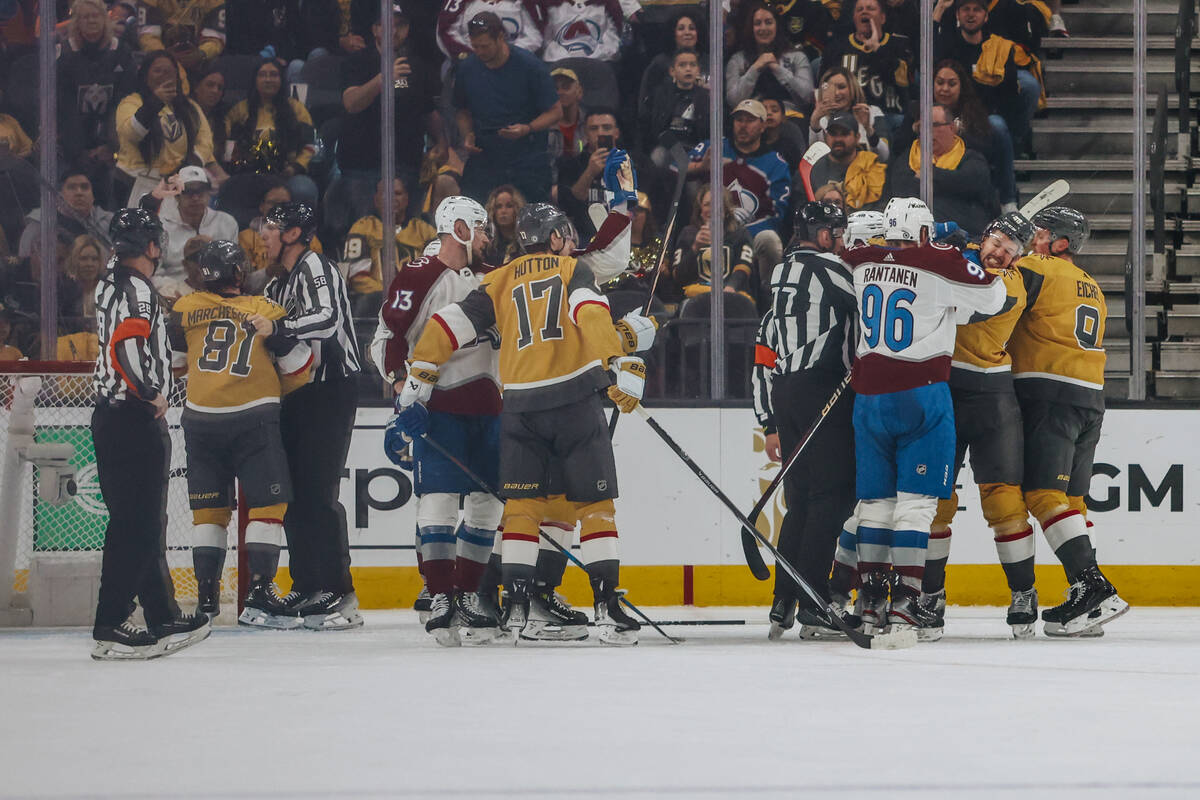 A fight breaks out between Colorado Avalanche and Golden Knights players down the ice during an ...