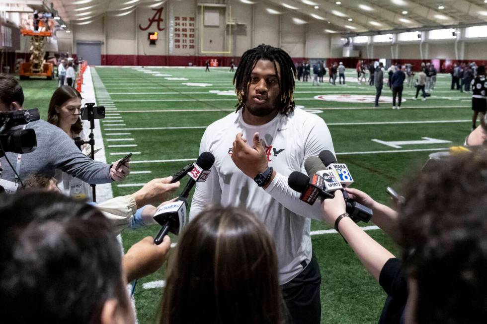 Former Alabama offensive lineman JC Latham talks with the media at Alabama's NFL football pro d ...