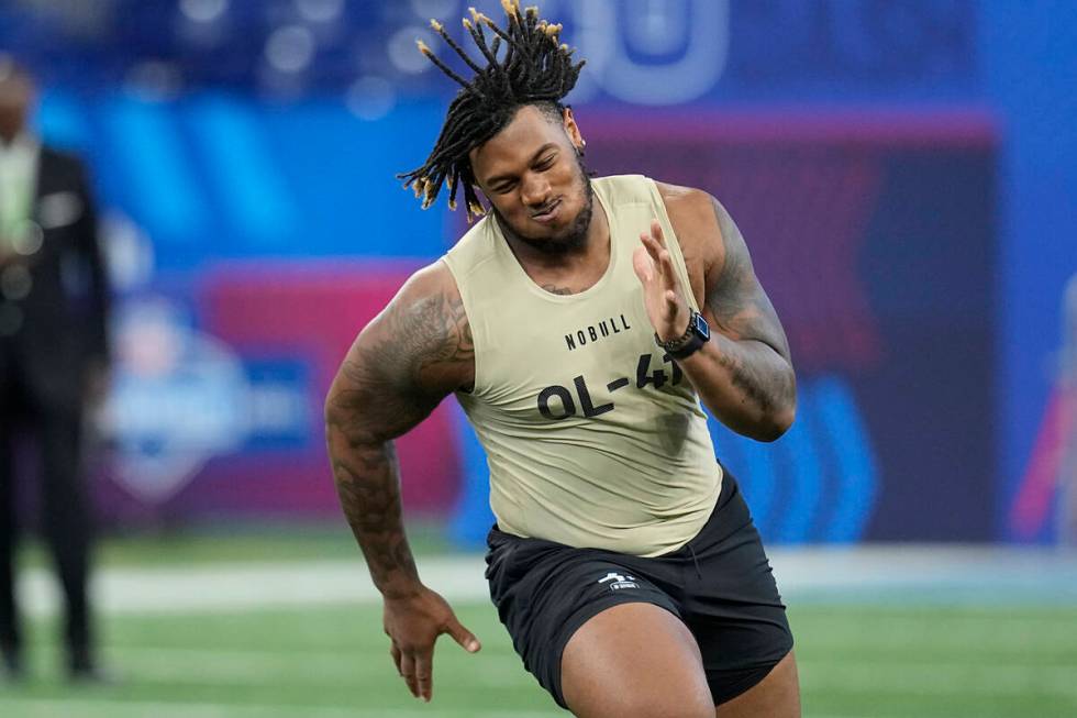 Alabama offensive lineman JC Latham runs a drill at the NFL football scouting combine, Sunday, ...