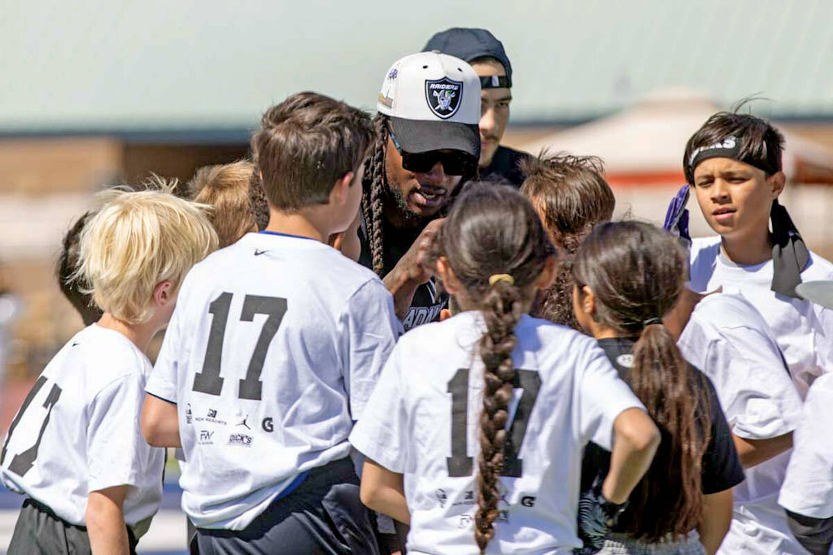 Raiders wide receiver Davante Adams gives instruction to participants of his youth camp on Sund ...