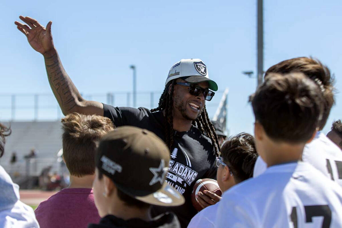 Raiders wide receiver Davante Adams gives instruction to participants of his youth camp on Sund ...