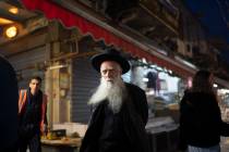 An elderly ultra-Orthodox Jewish man looks on as he walks in the Mahane Yehuda market in Jerusa ...