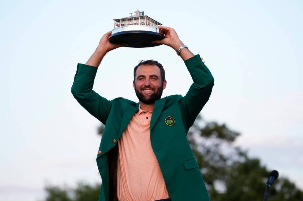 Scottie Scheffler holds the trophy after winning the Masters golf tournament at Augusta Nationa ...