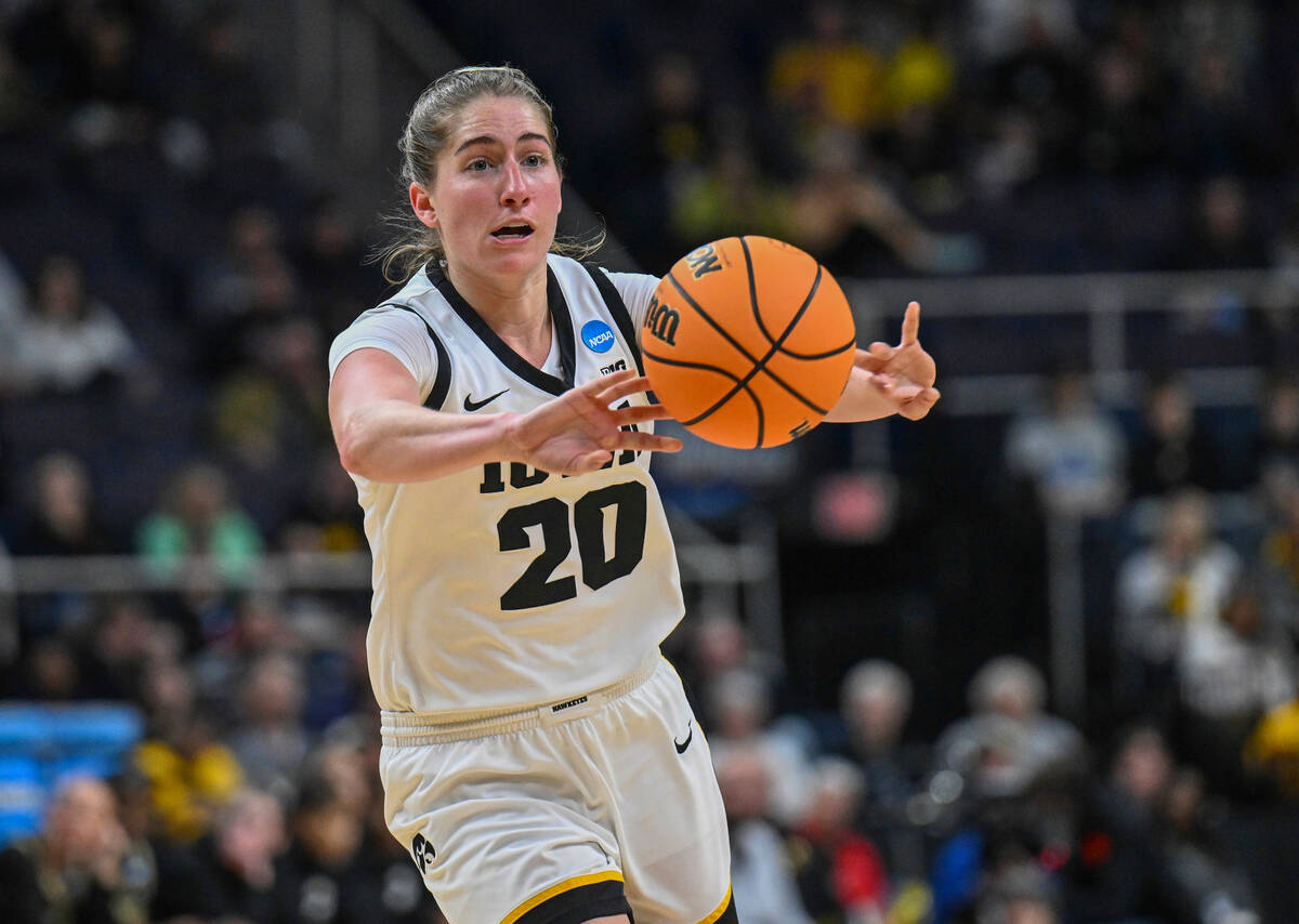 Iowa guard Kate Martin (20) passes the ball against Colorado during the first half of a Sweet 1 ...