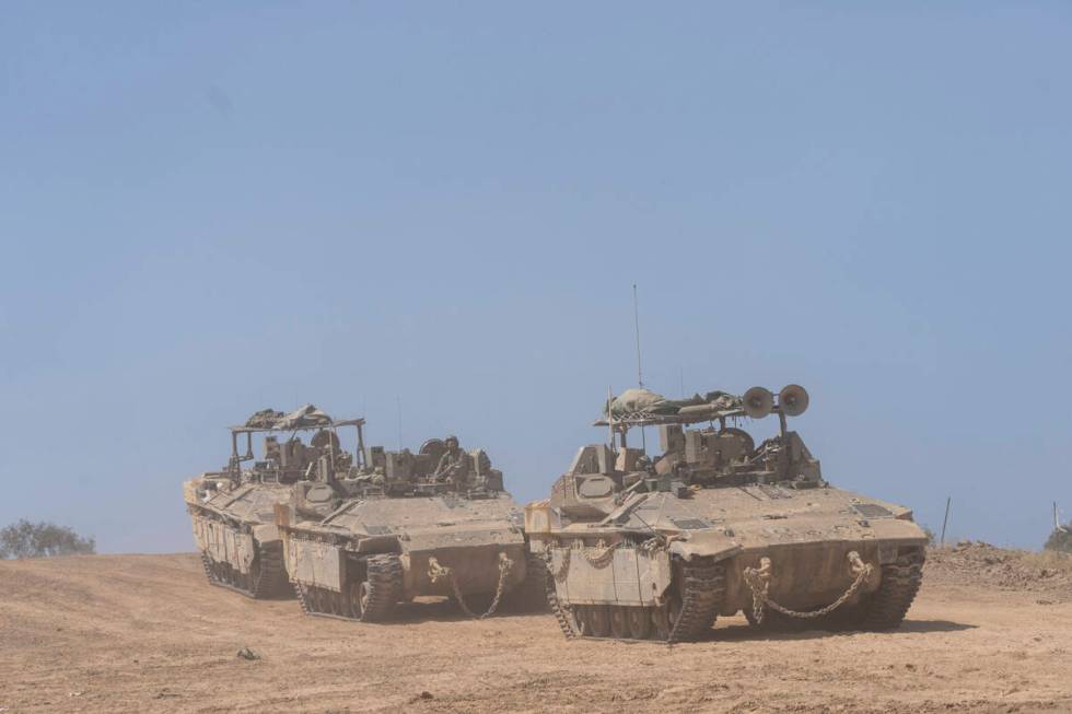 Israeli soldiers drive personnel carriers (APC) near the border with Gaza Strip, in southern Is ...