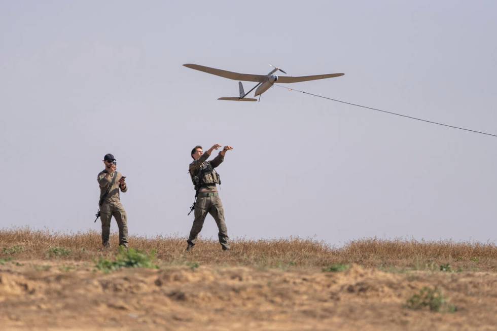 Israeli soldiers launch a drone near the Israeli-Gaza border, southern Israel, Monday, April 15 ...