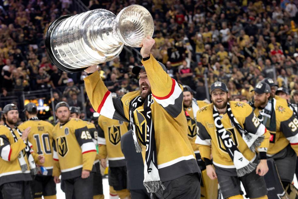 Golden Knights right wing and captain Mark Stone holds up the Stanley Cup after winning Game 5 ...