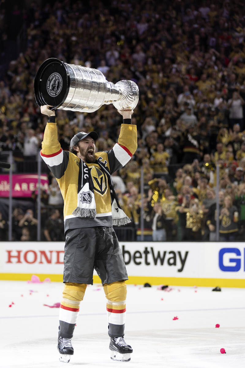 Golden Knights right wing and captain Mark Stone holds up the Stanley Cup after winning Game 5 ...