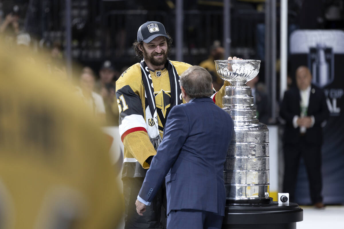 Golden Knights captain Mark Stone accepts the Stanley Cup from NHL commissioner Gary Bettman af ...