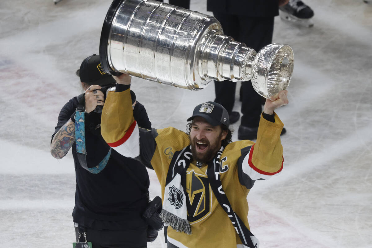 Golden Knights right wing Mark Stone (61) hoists the Stanley Cup after Golden Knights beat Flor ...