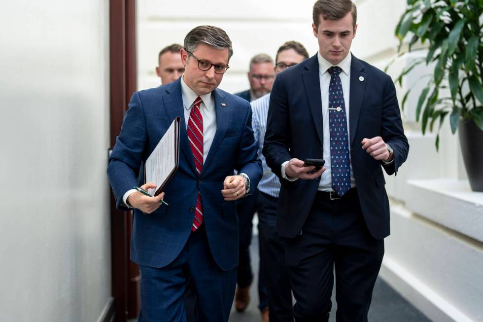 House Speaker Mike Johnson, R-La., left, arrives for a closed-door meeting with fellow Republic ...