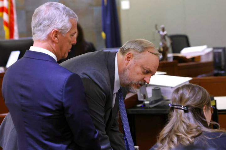 Attorney Tome Dillard, center, representing Clark County, reviews documents as attorney James P ...