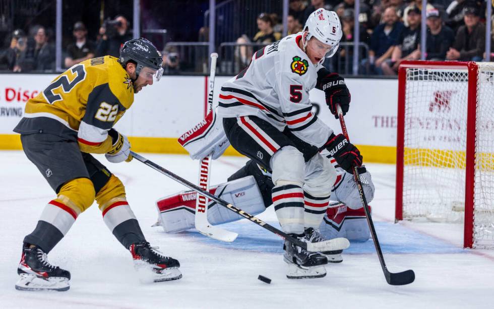 Golden Knights right wing Michael Amadio (22) battles for the puck against Chicago Blackhawks d ...