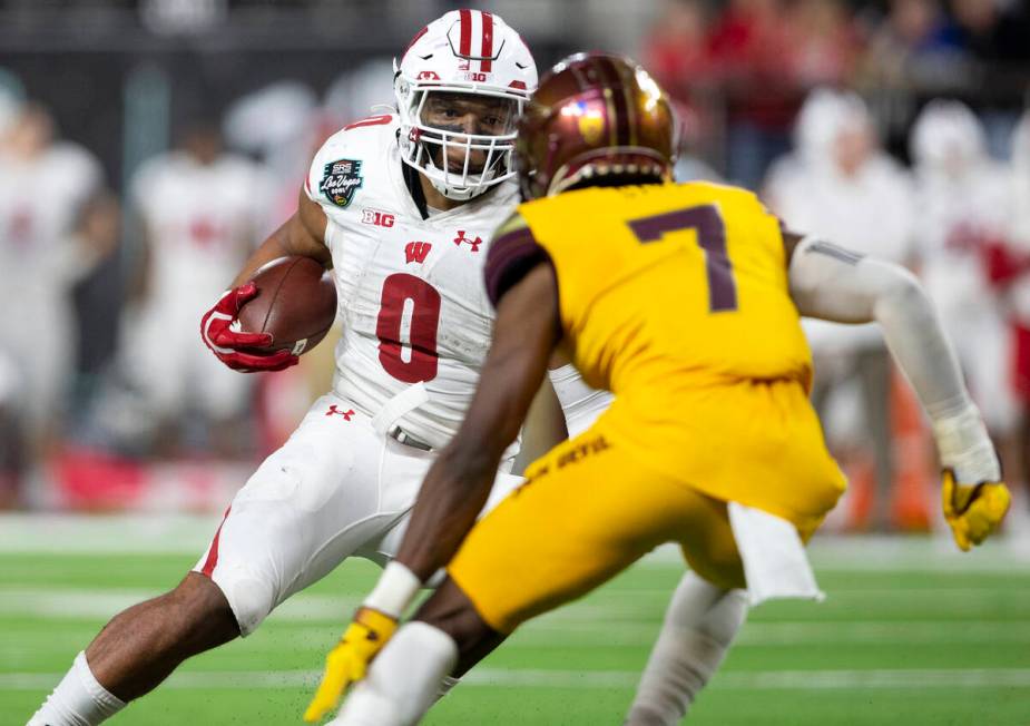 Wisconsin Badgers running back Braelon Allen (0) drives around Arizona State Sun Devils defensi ...