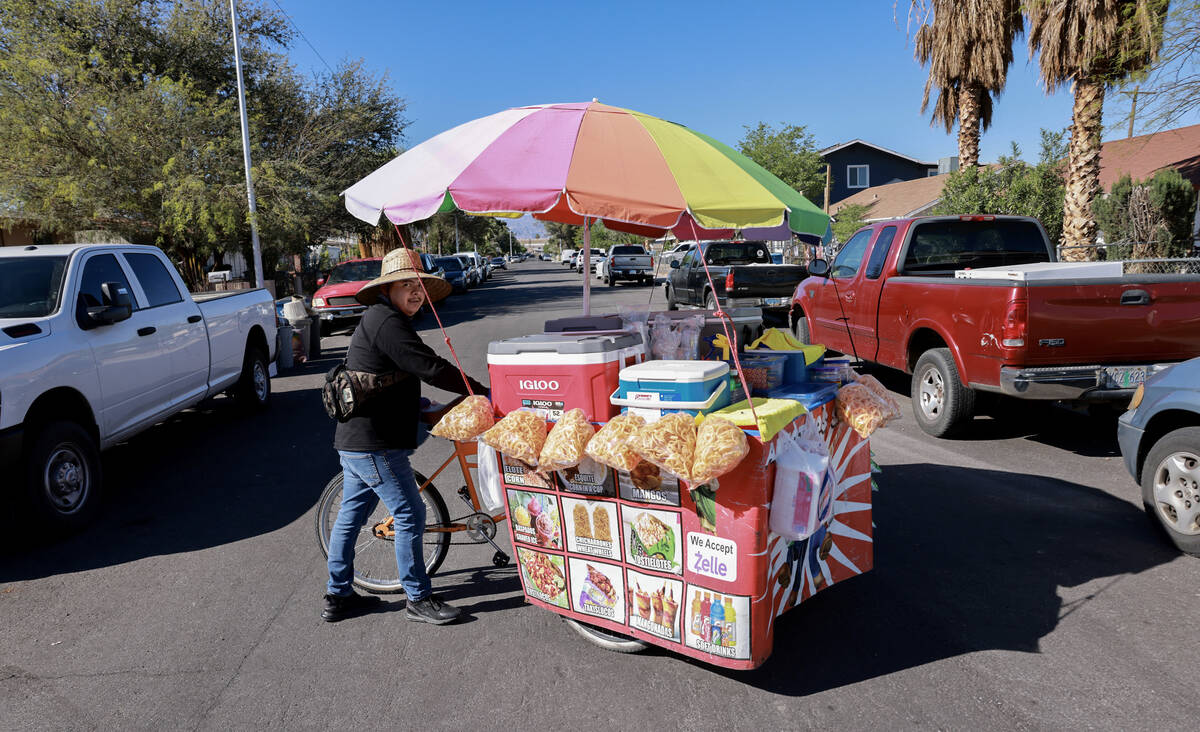 Sidewalk vendor Samuel Gonzalez makes his way to a customer in Las Vegas Tuesday, April 16, 202 ...