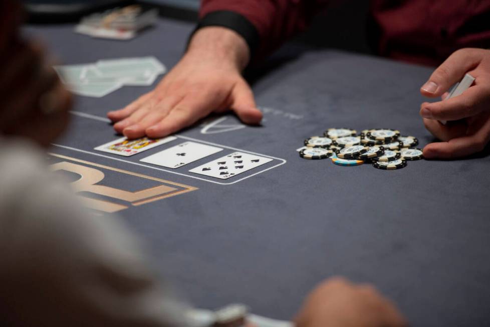 A dealer plays out a hand of poker at the PokerGO studio at Aria for the $25,000 free roll befo ...