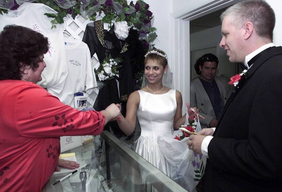 Wedding coordinator Marcy Wheeler congratulates newlyweds Claudia and Otto Delgado after their ...