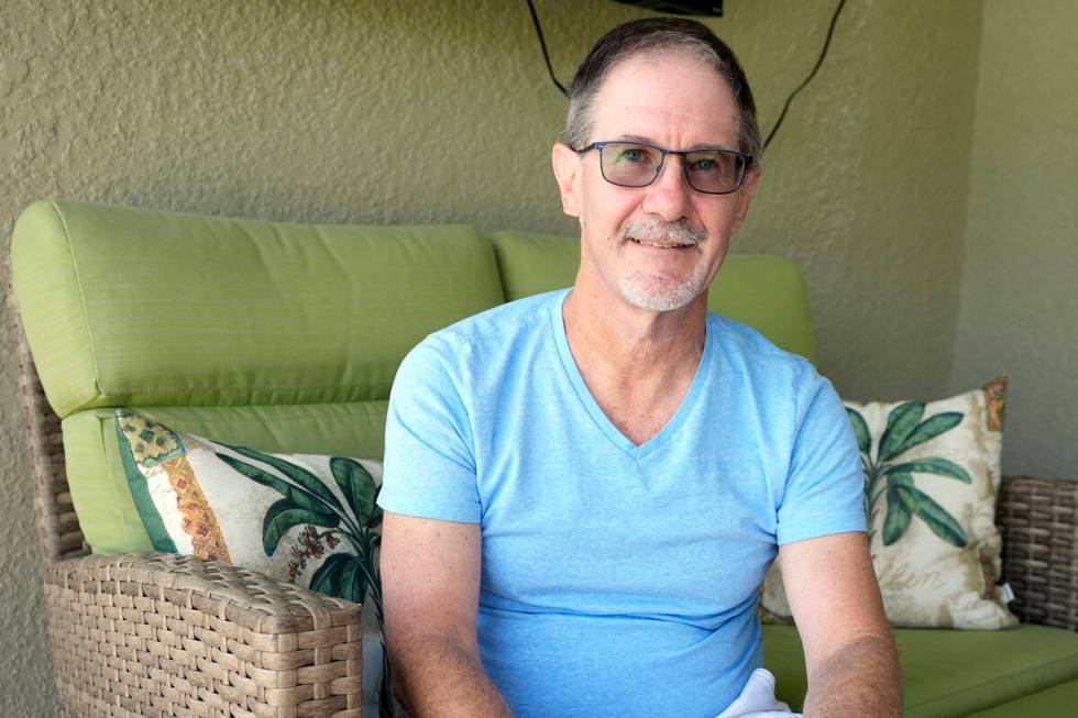 Scott Berkheiser, 57, who has Alzheimer's disease, sits for a portrait at his home Friday, Apri ...