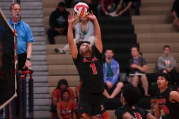Mojave setter Gabriel Revuelto (1) sets the ball during a boys high school volleyball game at L ...