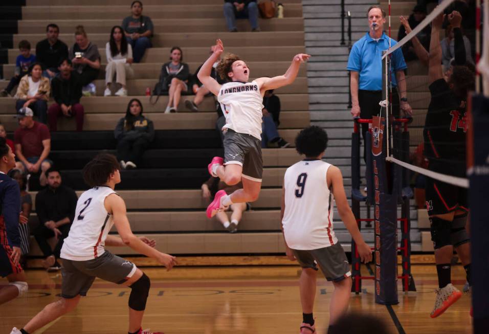 Legacy's Logan Hanshew (10) looks to spike the ball against Mojave during a boys high school vo ...