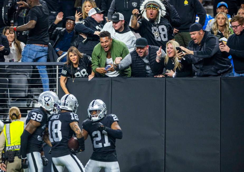 Raiders fans celebrate an interception and touchdown by cornerback Jack Jones (18) against the ...