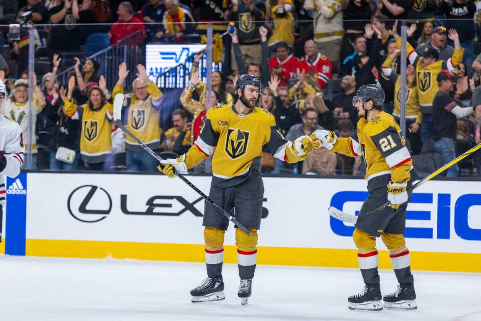 Golden Knights center Nicolas Roy (10) and center Brett Howden (21) celebrate the third goal of ...