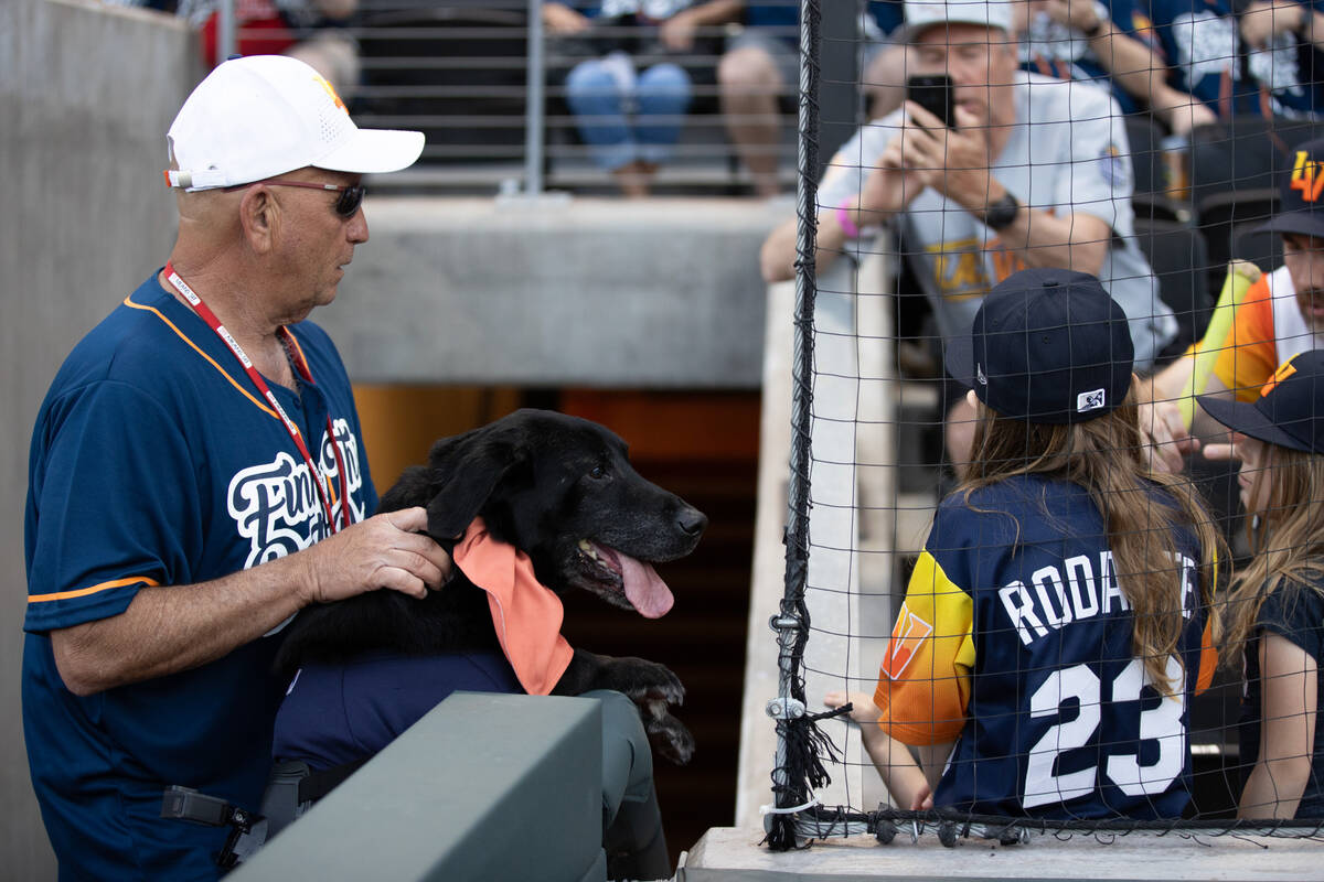 Fred Hassen and Finn the Bat Dog greet fans before a Minor League Baseball game at Las Vegas Ba ...