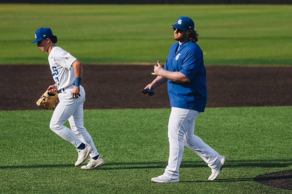 Bishop Gorman interim head coach Jeff Malm walks back from the field to the dug out during an b ...