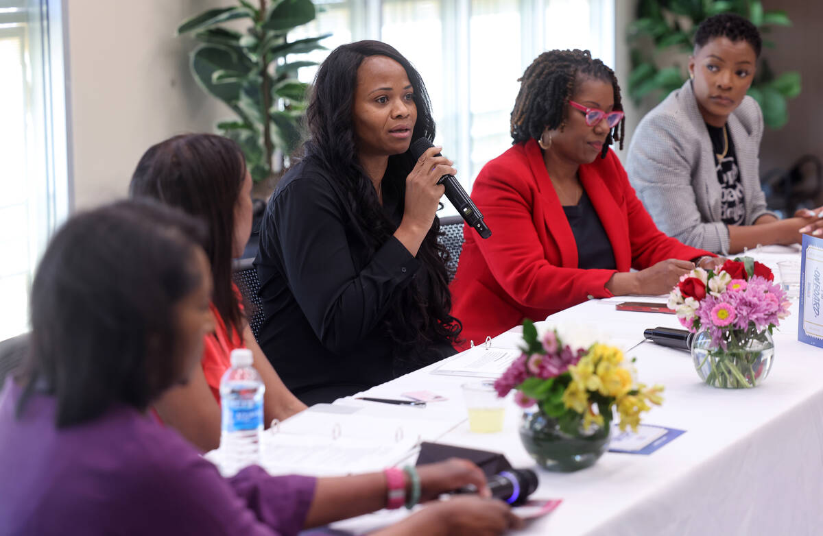 Shenakwa Hawkins, center, a nurse practitioner with Care With Purpose Medical Center, speaks du ...