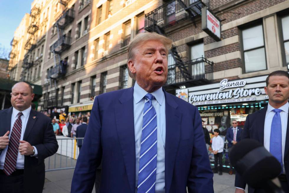 Former president Donald Trump, talks to members of the media while visiting a bodega, Tuesday, ...