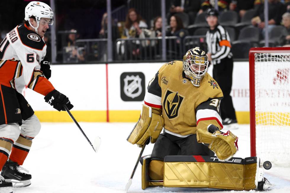 Ducks right wing Sam Colangelo (64) attempts a shot on Golden Knights goaltender Adin Hill (33) ...